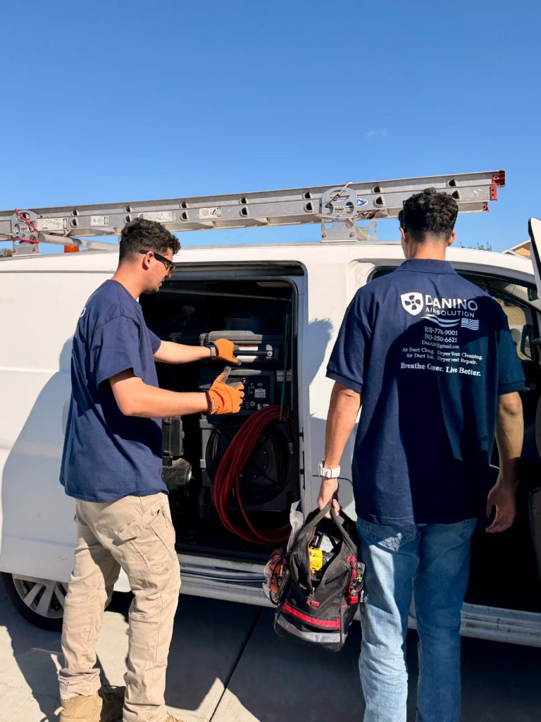 A Danino Air Solution technician cleaning a dryer vent
